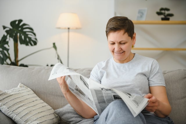 https://www.vecteezy.com/photo/39340485-middle-aged-woman-sitting-sofa-and-reading-newspapers