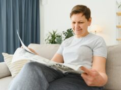 https://www.vecteezy.com/photo/39353486-middle-aged-woman-sitting-sofa-and-reading-newspapers