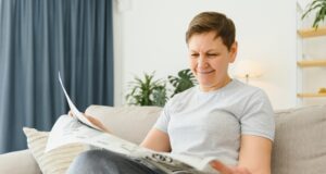 https://www.vecteezy.com/photo/39353486-middle-aged-woman-sitting-sofa-and-reading-newspapers