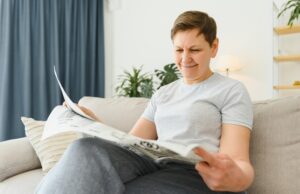 https://www.vecteezy.com/photo/39353486-middle-aged-woman-sitting-sofa-and-reading-newspapers