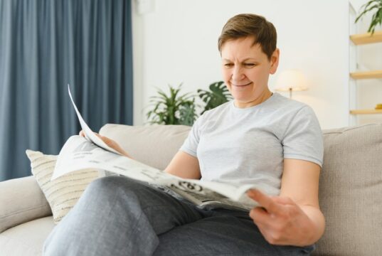https://www.vecteezy.com/photo/39353486-middle-aged-woman-sitting-sofa-and-reading-newspapers