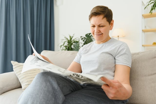 https://www.vecteezy.com/photo/39353486-middle-aged-woman-sitting-sofa-and-reading-newspapers