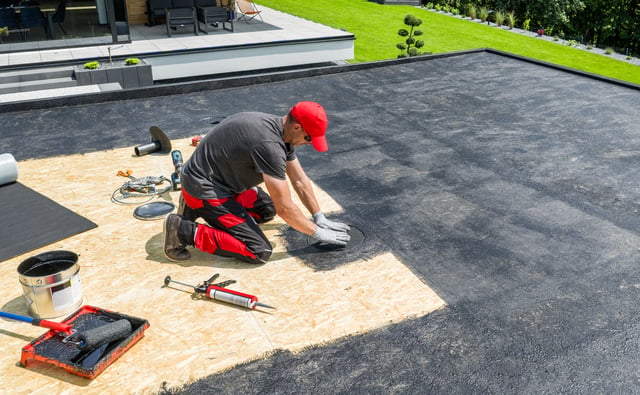 Roofer Applying Waterproof Membrane on Flat Roof During Sunny Afternoon https://www.vecteezy.com/photo/67548237-roofer-applying-waterproof-membrane-on-flat-roof-during-sunny-afternoon