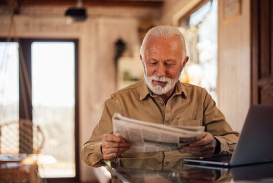 https://www.vecteezy.com/photo/79515719-senior-man-enjoying-at-home-reading-a-newspaper-while-having-a-laptop-in-front-of-him