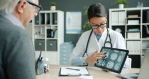 https://unsplash.com/photos/doctor-shows-patient-brain-scans-on-tablet-X_tBkG0U9yM