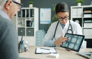 https://unsplash.com/photos/doctor-shows-patient-brain-scans-on-tablet-X_tBkG0U9yM