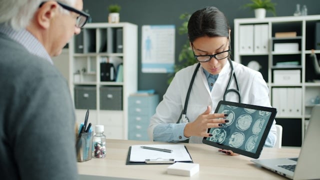 https://unsplash.com/photos/doctor-shows-patient-brain-scans-on-tablet-X_tBkG0U9yM