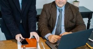 https://www.pexels.com/photo/crop-colleagues-gathering-at-table-with-laptop-in-office-5668796/