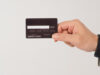 https://www.vecteezy.com/photo/14215212-a-hand-is-holding-back-of-black-credit-cards-and-wearing-a-suit-on-white-background