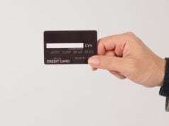 https://www.vecteezy.com/photo/14215212-a-hand-is-holding-back-of-black-credit-cards-and-wearing-a-suit-on-white-background