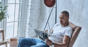 https://www.vecteezy.com/photo/13521993-resting-at-home-handsome-young-african-man-reading-newspaper-and-holding-a-cup-while-sitting-in-the-armchair-at-home