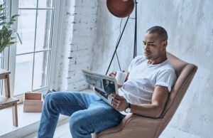 https://www.vecteezy.com/photo/13521993-resting-at-home-handsome-young-african-man-reading-newspaper-and-holding-a-cup-while-sitting-in-the-armchair-at-home