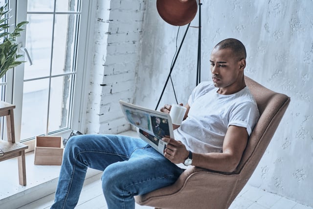 https://www.vecteezy.com/photo/13521993-resting-at-home-handsome-young-african-man-reading-newspaper-and-holding-a-cup-while-sitting-in-the-armchair-at-home