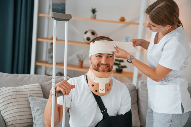 Taking care of bandage on the head. Woman is helping injured man at home https://www.vecteezy.com/photo/59175841-taking-care-of-bandage-on-the-head-woman-is-helping-injured-man-at-home