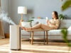 How to Improve Indoor Air Quality in Florida Homes https://www.vecteezy.com/photo/73915570-a-woman-sitting-on-a-couch-in-front-of-a-white-air-purifier