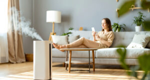 https://www.vecteezy.com/photo/73915570-a-woman-sitting-on-a-couch-in-front-of-a-white-air-purifier