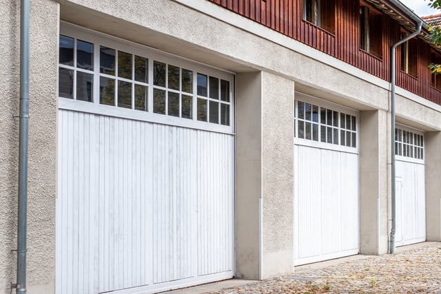 https://www.vecteezy.com/photo/72517857-bern-switzerland-three-white-garage-doors-with-wooden-accents-set-against-a-textured-concrete-wall-showcasing-modern-architecture-and-design-elements-in-a-residential-environment