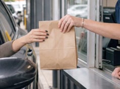 Drive-Thrus Led To The Installation Of Cup Holders In Vehicles https://www.vecteezy.com/photo/81926305-handing-over-a-takeout-bag