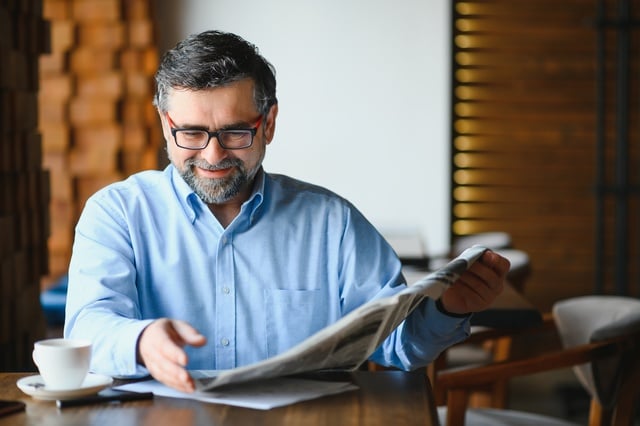 Newspaper in the morning. Senior businessman at his office riding newspapers. https://www.vecteezy.com/photo/39354020-newspaper-in-the-morning-senior-businessman-at-his-office-riding-newspapers