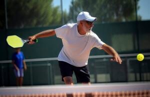 Pickleball, Tennis, Soccer: How Social Sports Keep You Mentally and Physically Young https://www.vecteezy.com/photo/22952208-photo-of-an-elderly-man-holding-a-pickleball-racket-on-a-pickleball-court-generative-ai