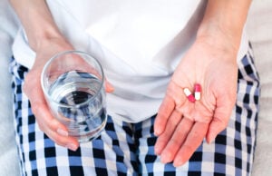 The Drink You Take With Your Pills Could Affect How Well They Work https://www.vecteezy.com/photo/40163412-young-woman-holds-two-pills-and-glass-of-water-in-hands-taking-vitamins-supplements-antibiotic-antidepressant-painkiller-medication-prenatal-vitamins-close-up