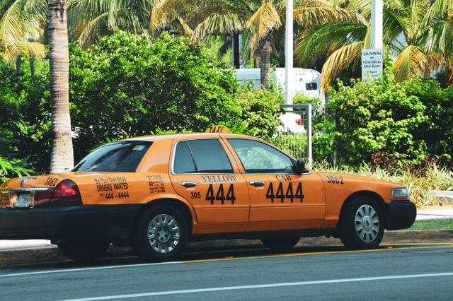 https://www.pexels.com/photo/yellow-taxi-on-miami-street-with-lush-palms-34521713/