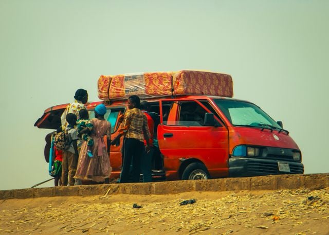 https://www.pexels.com/photo/family-traveling-with-van-on-dusty-road-35037876/