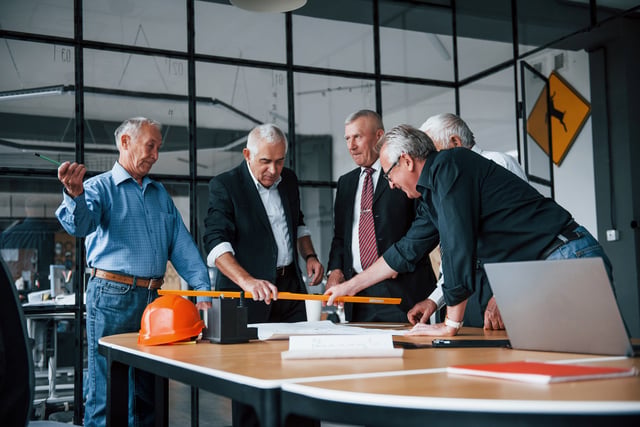Aged team of elderly businessman architects works with plan in the office https://www.vecteezy.com/photo/15241822-aged-team-of-elderly-businessman-architects-works-with-plan-in-the-office