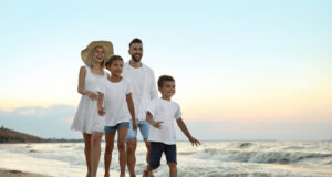 https://www.vecteezy.com/photo/82208884-happy-family-walking-on-sandy-beach-near-sea-at-sunset