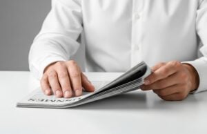 https://www.vecteezy.com/photo/67965441-man-reading-a-newspaper-at-a-table-in-a-white-shirt