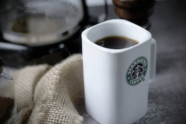 WASHINGTON - USA September, 26 2022 : Starbucks coffee mug on gr https://www.vecteezy.com/photo/12565984-washington-usa-september-26-2022-starbucks-coffee-mug-on-gray-table-with-coffee-bottle-and-coffee-grinder