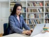 How Much Should You Budget for an Online LMS Course Platform? https://www.vecteezy.com/photo/68905002-a-woman-with-glasses-using-a-laptop-in-a-library-with-bookshelves-in-the-background-she-is-studying