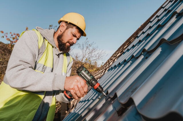 2148748771 https://www.magnific.com/free-photo/sideways-man-working-roof-with-drill_11106226.htm#fromView=search&page=1&position=24&uuid=723d1328-0536-4726-80f7-5ea40887feeb&track=ais_hybrid&query=metal+roof