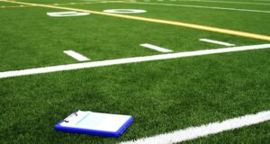 https://unsplash.com/photos/a-notebook-sitting-on-the-side-of-a-football-field-Rn6n5Lh1BdA?utm_source=unsplash&utm_medium=referral&utm_content=creditCopyText