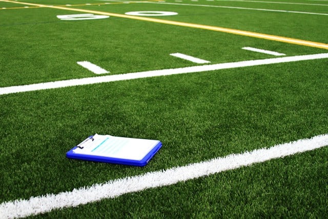 mario-verduzco-Rn6n5Lh1BdA-unsplash https://unsplash.com/photos/a-notebook-sitting-on-the-side-of-a-football-field-Rn6n5Lh1BdA?utm_source=unsplash&utm_medium=referral&utm_content=creditCopyText