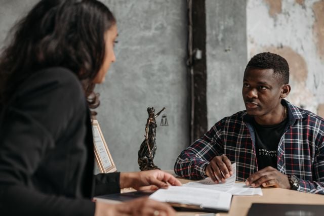 Photo by Pavel Danilyuk: https://www.pexels.com/photo/a-man-in-checkered-long-sleeves-talking-to-his-lawyer-8111884/