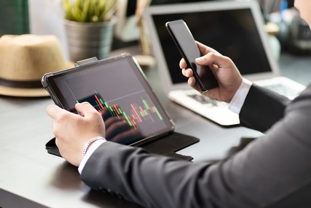 Business man use digital tablet.pointing device screen and holdi https://www.vecteezy.com/photo/7196385-business-man-use-digital-tablet-pointing-device-screen-and-holding-smart-phone-on-desk-at-home-office-work-from-home-business-and-technology-concept